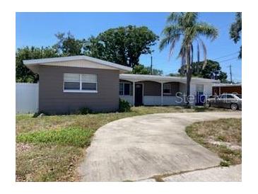 Inviting single-story home with a spacious front yard and a classic driveway, creating a welcoming curb appeal at 1811 Ridge S Rd, Largo, FL 33778