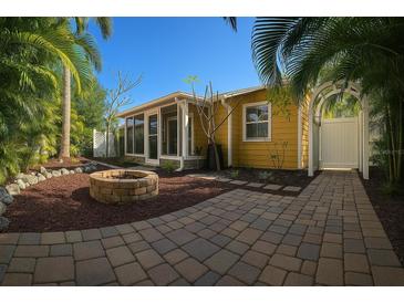 Charming yellow home with a fire pit and lush tropical landscaping creating an inviting outdoor space at 4710 22Nd N Ave, St Petersburg, FL 33713