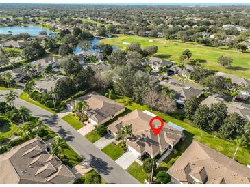 Expansive aerial view showcases home's prime location near golf course and serene lake at 1912 Acadia Greens Dr, Sun City Center, FL 33573