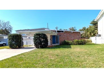 Charming single-story home featuring a well-maintained lawn and a convenient carport at 602 Danube Ave, Tampa, FL 33606