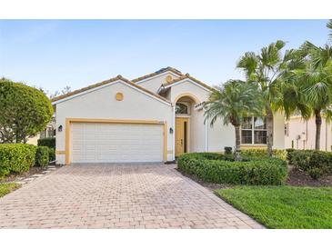 Charming one-story home with brick driveway, a two-car garage and tropical landscaping at 6431 43Rd E Ct, Sarasota, FL 34243