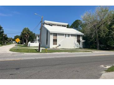 Unique architecture is highlighted in this two story home's exterior elevation at 1909 S West Shore Blvd, Tampa, FL 33629