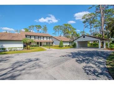 Charming two-story home with attached carport, manicured landscaping and large driveway at 5434 Saddlebrook Way # 3, Wesley Chapel, FL 33543