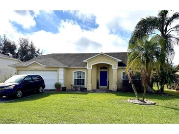 Charming one-story home with manicured lawn, blue front door, and attached two-car garage at 2717 Wilder Trace Ct, Plant City, FL 33566