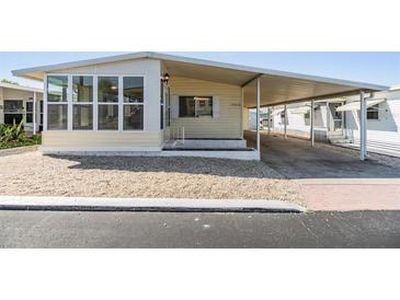 Charming home with a covered carport and gravel landscaping for low maintenance appeal at 37838 Granada Ave, Zephyrhills, FL 33541