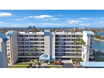 Beautiful multi-story condo building with manicured landscaping and ocean views at 7892 Sailboat Key S Blvd # 107, South Pasadena, FL 33707