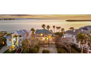 Stunning waterfront home with meticulous landscaping and charming curb appeal in a desirable neighborhood with views of the sea at 2077 N Pointe Alexis Dr, Tarpon Springs, FL 34689