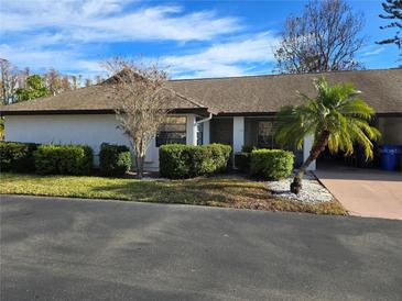 Charming single-story home featuring manicured hedges and a well-kept lawn with inviting curb appeal at 1606 Comfy Ct, Sun City Center, FL 33573