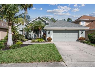 Charming single-story home boasts a well-manicured lawn and mature landscaping, enhancing its curb appeal at 10439 Greendale Dr, Tampa, FL 33626