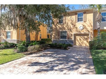 Charming home with a brick driveway and well-maintained landscaping at 13946 Snapper Fin Ln, Tampa, FL 33637