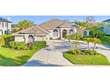 Stunning single-story home with lush landscaping, a circular driveway, and well-manicured lawns at 1227 Darlington Oak Ne Cir, St Petersburg, FL 33703