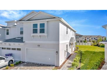 Charming two-story townhouse featuring an attached garage and manicured landscaping in a desirable community at 31869 Anchor Point Dr, Wesley Chapel, FL 33545