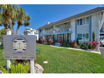 Well-maintained condo complex with lush landscaping and a welcoming entrance sign at 4400 37Th S St # 2, St Petersburg, FL 33711