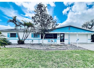 Charming single-story home with white exterior, blue trim, and well-maintained landscaping at 6398 17Th N Pl, St Petersburg, FL 33710