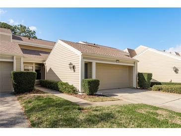 Charming townhome with a one-car garage and well-maintained landscaping at 3130 Eagles Landing W Cir, Clearwater, FL 33761