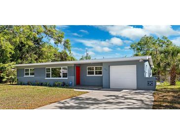 Charming single-story home with a well-maintained lawn and a red front door at 1119 77Th N St, St Petersburg, FL 33710