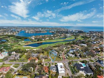 Scenic aerial view of a neighborhood with a golf course and waterfront, pinpointing the property location at 735 Snell Isle Ne Blvd, St Petersburg, FL 33704