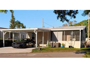 Cozy single-story home with a carport and a screened-in porch for comfortable outdoor living at 1668 Mary Ln # 341, Lutz, FL 33558