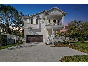 Charming two-story home featuring a welcoming front porch and a spacious two-car garage at 3201 S Manhattan Ave, Tampa, FL 33629
