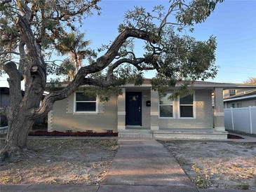 Charming single-story home features a brick facade, front porch, and mature tree in a quiet neighborhood at 3711 1St S Ave, St Petersburg, FL 33711