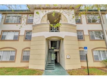 Condo building exterior featuring an arched entryway, stairwell, and decorative accents at 17108 Carrington Park Dr # 701, Tampa, FL 33647