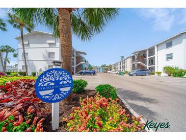 Condominium complex with mature landscaping and plentiful parking on a bright, sunny day at 2113 Canal Dr # B2, Bradenton, FL 34207