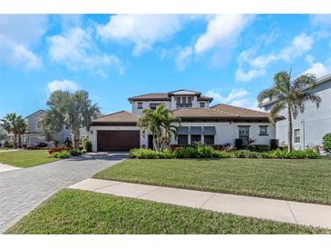 Beautiful single-Gathering home with a well-manicured lawn and tropical landscaping at 4054 Rocky Shores Dr, Tampa, FL 33634