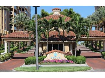 Belle Harbor entrance with tropical plants and a guard house, creating a secure community at 501 Mandalay Ave # 601, Clearwater Beach, FL 33767