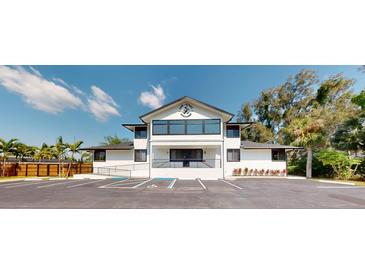 Modern two-story building featuring expansive windows, a well-maintained landscape, and convenient parking at 10787 Oak Ne St, St Petersburg, FL 33716