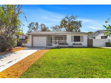 Charming single-story home with a well-manicured lawn, a lovely front porch and an attached garage at 1712 25Th N Ave # N, St Petersburg, FL 33713