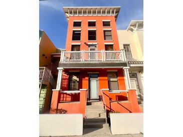 Eye-level view of multi-story red building with windows and white trim, enhanced curb appeal at 1914 E 4Th Ave # 2, Tampa, FL 33605