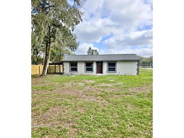 Charming single-story home featuring a cozy design and a well-maintained lawn at 20542 Old Trilby Rd, Dade City, FL 33523