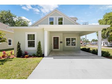 Charming home with a covered porch, well-manicured lawn, and updated landscaping at 25 W Edwards St, Plant City, FL 33563