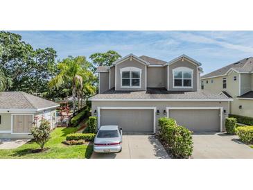 Charming two-story home with a two-car garage and well-manicured landscaping at 450 Harbor Springs Dr, Palm Harbor, FL 34683