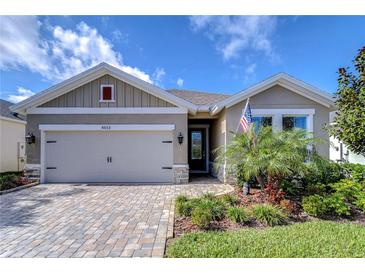 Charming single-story home with a brick driveway, well-maintained landscaping, and a two-car garage at 6113 Plover Meadow St, Lithia, FL 33547