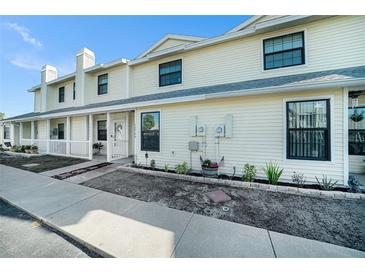 Inviting two-story condo with a charming front porch and well-maintained landscaping at 12709 Raeburn Way, Tampa, FL 33624