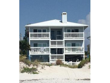 Three story beach house with white balconies overlooking beach at 712 Beach Trl # C, Indian Rocks Beach, FL 33785