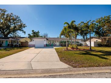 Charming single-story home with a well-manicured front yard and a long driveway at 2800 57Th N St, St Petersburg, FL 33710