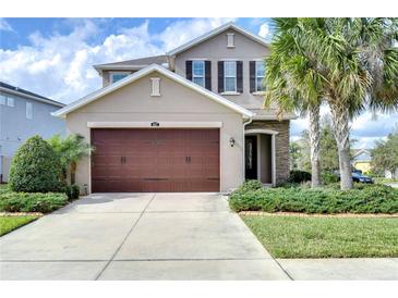 Charming two-story home featuring a spacious driveway, two car garage, and neatly landscaped front yard at 4627 Tramanto Ln, Wesley Chapel, FL 33543