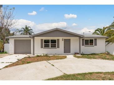 Charming single-story home with a well-maintained front yard and attached garage at 9321 Gray Fox Ln, Port Richey, FL 34668