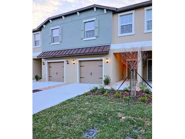 Charming townhome with a well-manicured lawn and two-car garage, perfect for modern living at 11115 Wishing Cloud Rd, Land O Lakes, FL 34638