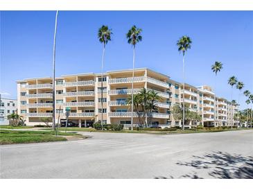 Low angle shot of a multi-story condo building with balconies and palm trees on a sunny day at 1200 N Shore Ne Dr # 110, St Petersburg, FL 33701