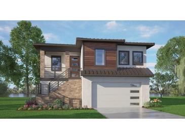 Modern two-story home with stone accents, sleek lines, and a two-car garage at 417 Tennessee Ave, Crystal Beach, FL 34681