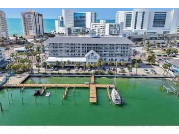 Stunning aerial view of condo building with private boat dock on waterfront property near the beach and city at 445 Hamden Dr # 201, Clearwater Beach, FL 33767