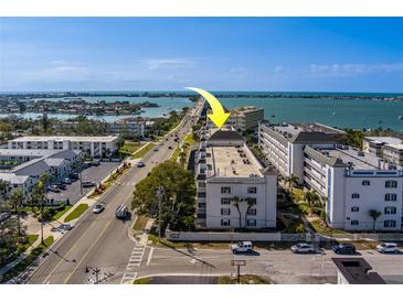 Aerial view of condo building with waterfront access, parking, and an ideal location near the beach and intercostal waterway at 131 Bluff View Dr # 208, Belleair Bluffs, FL 33770