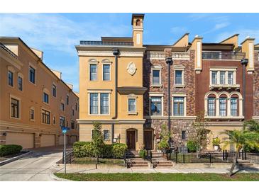 Stunning townhome showcasing a unique facade, neat landscaping, and inviting curb appeal at 2240 Soho Bay Ct, Tampa, FL 33606