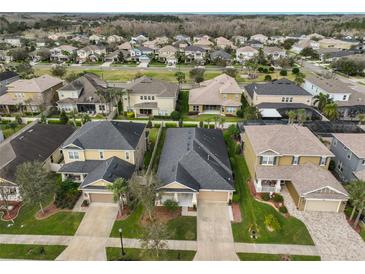 A beautiful aerial view of the house showing the neighborhood and roof top at 9244 Bella Vita Cir, Land O Lakes, FL 34637