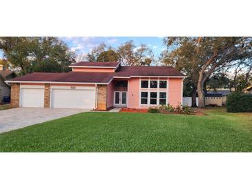 Charming home with a well-manicured lawn and a spacious two-car garage at 1550 Chateau Wood Dr, Clearwater, FL 33764