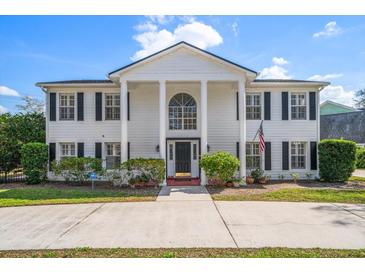Stunning two-story home featuring a grand entrance with white columns and a manicured lawn at 2102 S Fore Cir, Tampa, FL 33612
