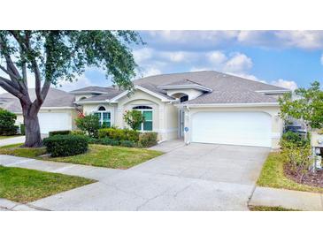 Charming single-story home featuring a two-car garage, well-manicured landscaping, and inviting curb appeal at 2166 Andrews Ct, Dunedin, FL 34698